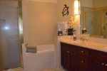 Master bathroom with a tub and shower, separate water closet and walk in closet